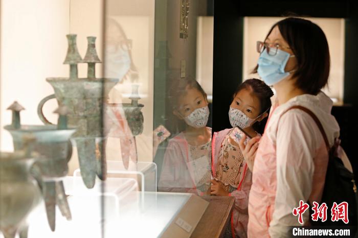 游客带着孩子戴着口罩在上海博物馆内观展。　殷立勤 摄