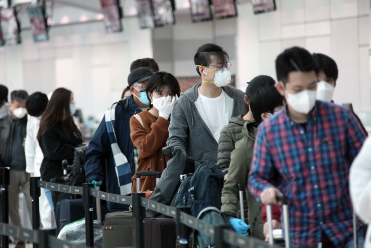 当地时间4月22日，准备飞赴中国的乘客在加拿大多伦多皮尔逊国际机场排队办理值机手续。乘客中的大多数为中国留学生。（图片来源：中新社）