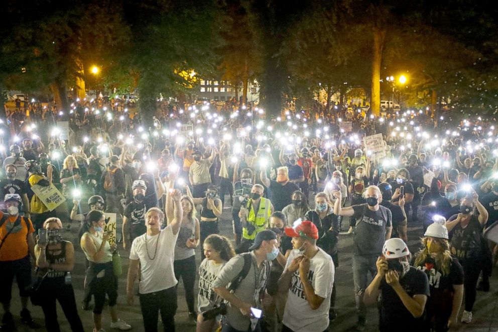 PHOTO: Demonstrators raise their cell phone lights as they chant slogans during a Black Lives Matter protest in Portland, Ore., July 29, 2020.