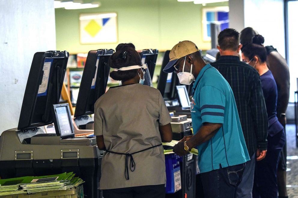 PHOTO: Voters cast their early ballots at the Miami Dade Regional Library in Miami, Oct. 28, 2020.