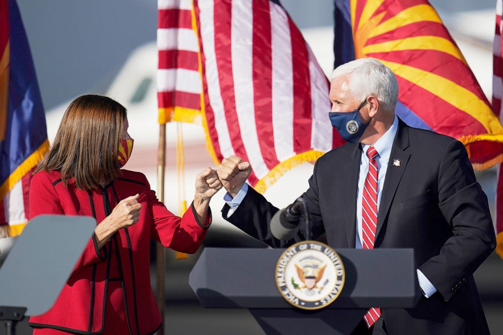 PHOTO: Vice President Mike Pence gives Sen. Martha McSally a fist bump after Pence spoke at a campaign rally at Tucson International Airport, Oct. 30, 2020.