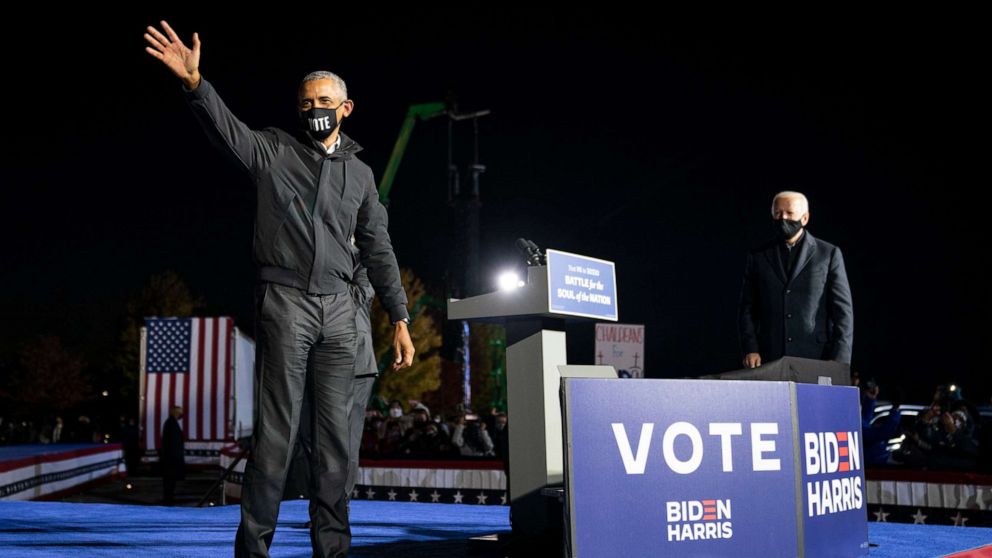 PHOTO: Former President Barack Obama waves at the end of a drive-in campaign rally with Democratic presidential nominee Joe Biden at Belle Isle on Oct. 31, 2020, in Detroit.
