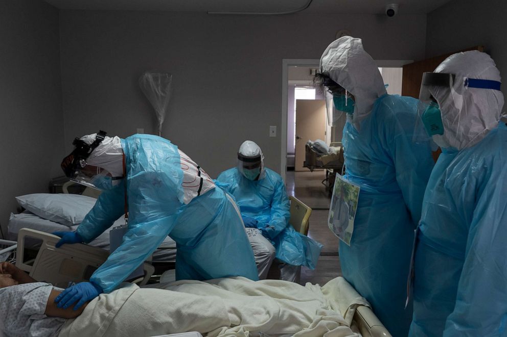 PHOTO: Medical staff examine a patient suffering from coronavirus in the COVID-19 intensive care unit at United Memorial Medical Center on Nov. 16, 2020, in Houston.