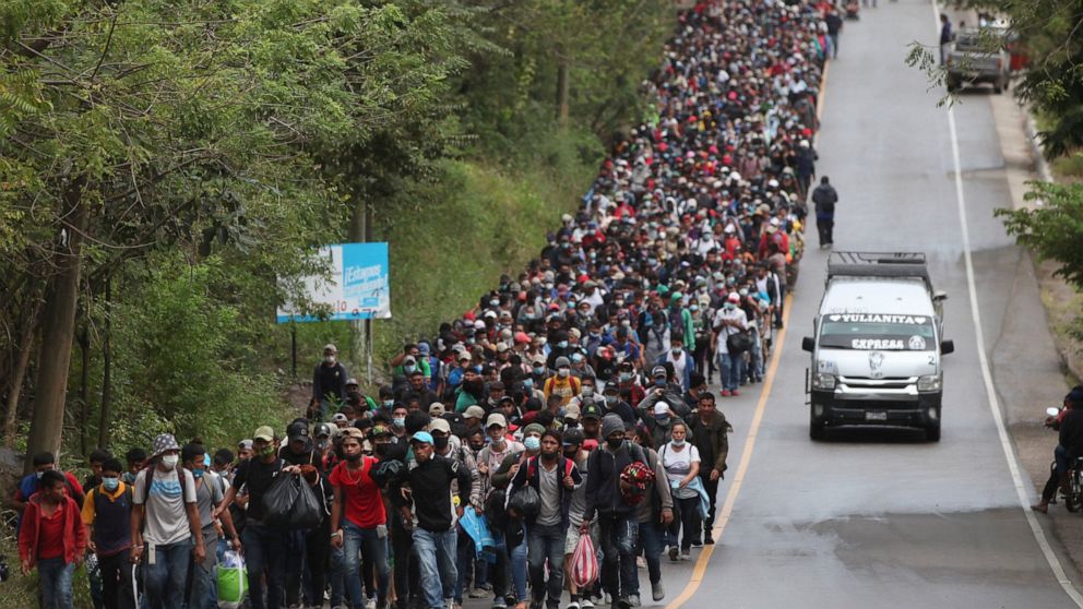 Migrants hoping to reach the U.S. border walk alongside a highway in Chiquimula, Guatemala, Saturday, Jan. 16, 2021. Honduran migrants pushed their way into Guatemala Friday night without registering, a portion of a larger migrant caravan that had le