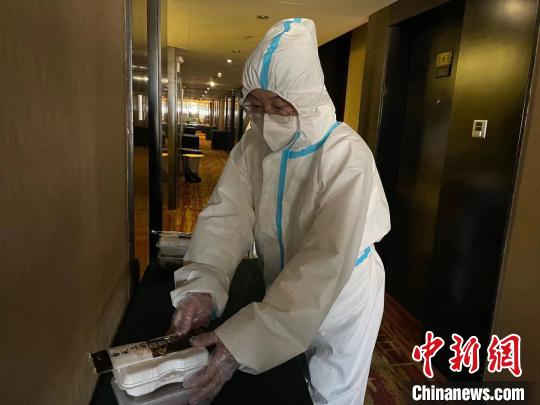 中国侨网服务员将医务工作者的配餐放到房间门口桌子上　李茜　摄