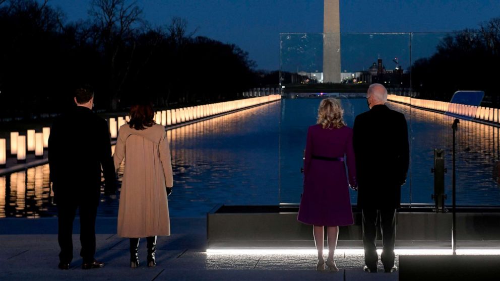 PHOTO: Vice President-elect Kamala Harris and President-elect Joe Biden watch as a Covid-19 Memorial is lit at the Lincoln Memorial in Washington, DC, Jan. 19, 2021 to honor the lives of those lost to Covid-19.