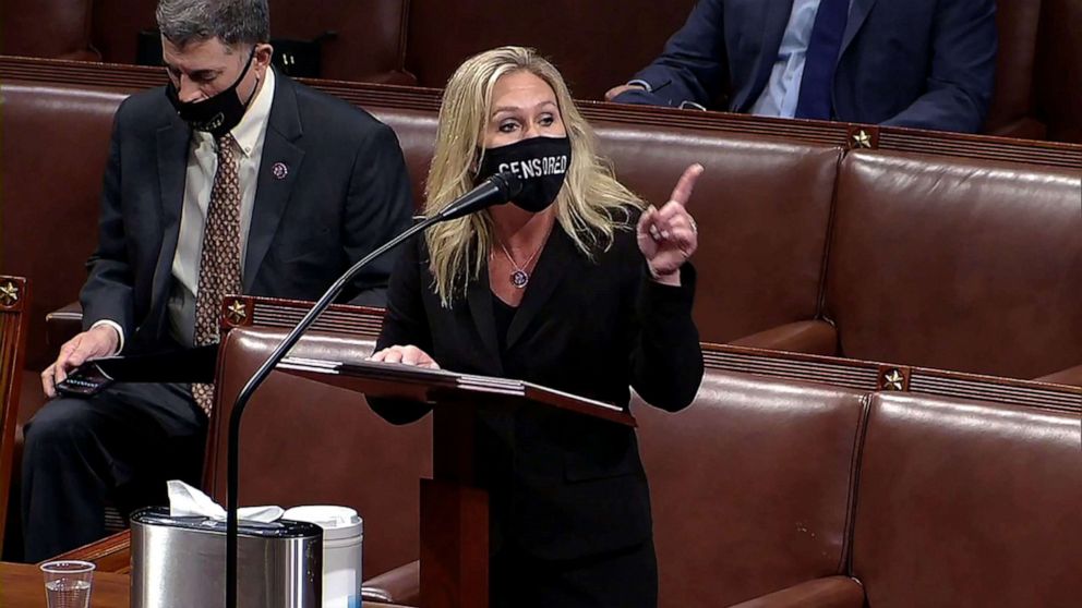 PHOTO: Rep. Marjorie Taylor Greene speaks during debate ahead of the House vote on impeachment against President Donald Trump, while wearing a mask that reads, 