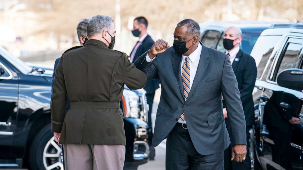 PHOTO: Mark Milley, Chairman of the Joint Chiefs of Staff, greets incoming Secretary Of Defense Lloyd Austin III outside of the Pentagon on Austin's first day in his new role  in Arlington, Va., Jan. 22, 2021.
