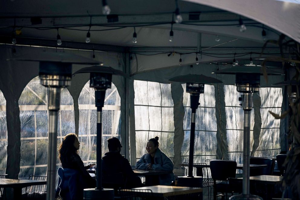 PHOTO: Customers sit inside an outdoor dining tent of a restaurant in Chicago, Nov. 13, 2020. 