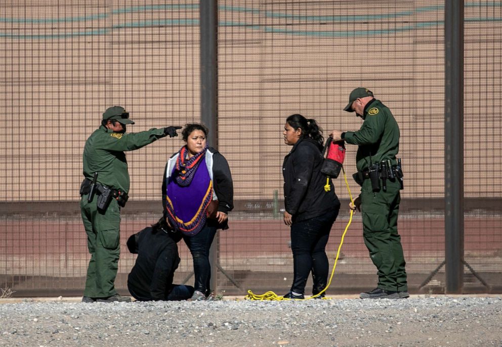 PHOTO: U.S. Border Patrol agents detain undocumented immigrants next to the U.S.-Mexico border fence after the women crossed the Rio Grande into El Paso, March 17, 2021, in Ciudad Juarez, Mexico.