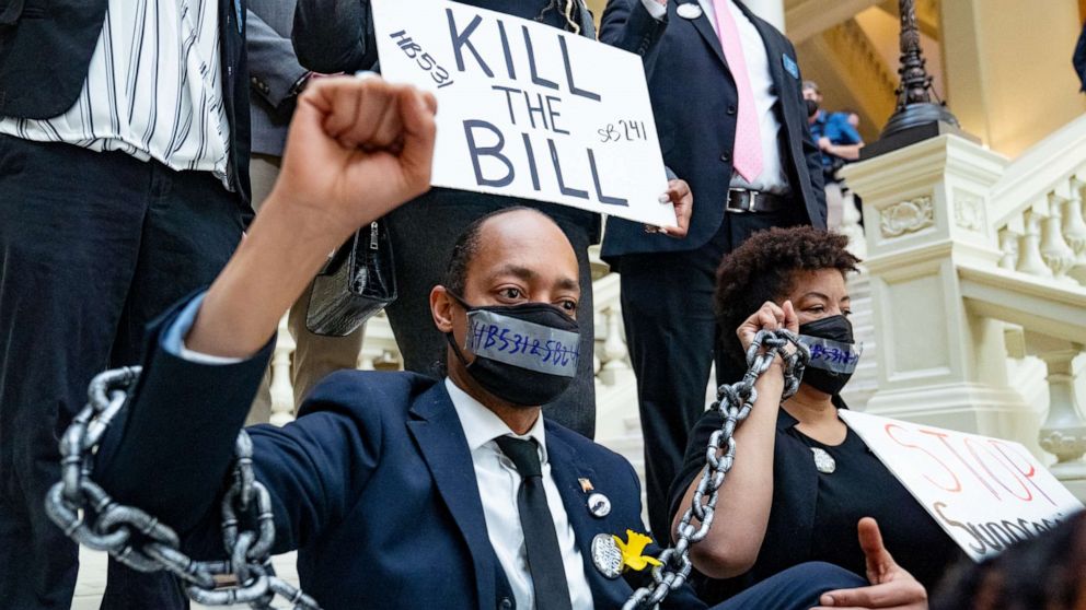 PHOTO: Demonstrators wear chains, March 8, 2021, while holding a sit-in inside of the Capitol building in Atlanta, in opposition of House Bill 531, one of the bills the GOP-led state legislature has been considering that would limit voting rights.