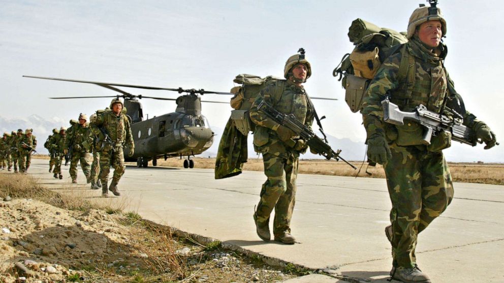 PHOTO: U.S. Army soldiers from the 10th Mountain and the 101st Airborne units disembark from a Chinook helicopter March 11, 2002 as they return to Bagram airbase from the fighting in eastern Afghanistan.