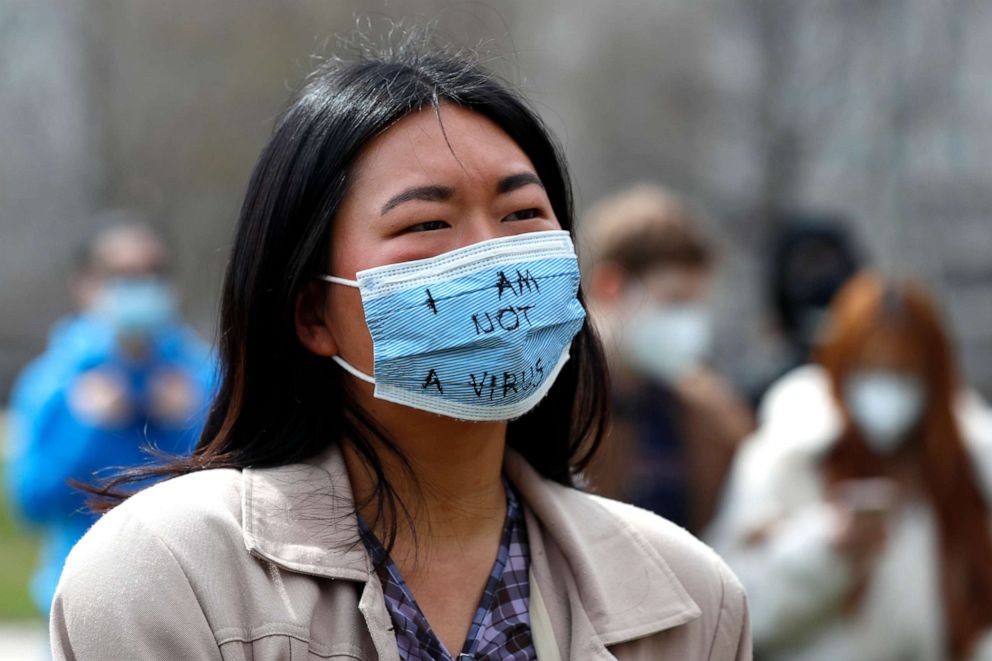 PHOTO: A demonstrator wearing a mask saying 