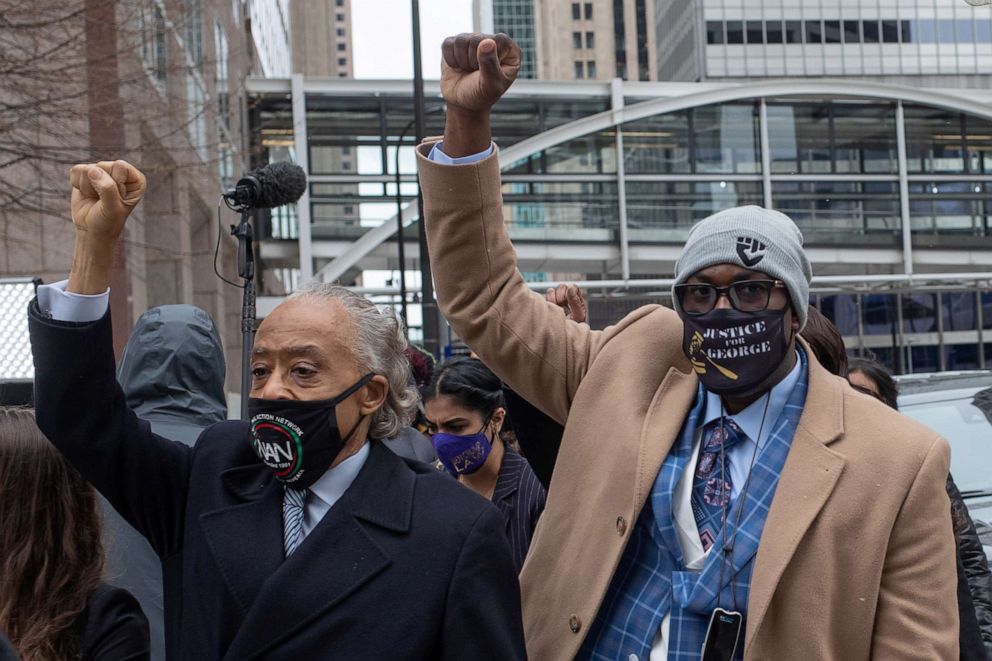 PHOTO: Philonise Floyd raises his fist as he arrives with Reverend Al Sharpton to the Hennepin County Government Center for closing arguments in the murder trial of former police officer Derek Chauvin in Minneapolis, Minnesota, April 19, 2021.