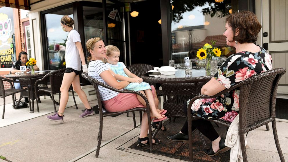 PHOTO:Women sit at a table outside Farmhouse Kitchen, June 5, 2020 in West Reading, Penn.