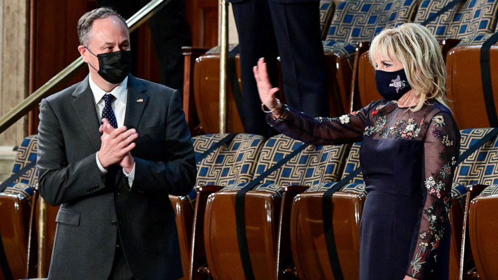 PHOTO: First Lady Jill Biden waves next to Second Gentleman Doug Emhoff as they greet the arrival President Joe Biden to address a joint session of Congress at the Capitol, April 28, 2021.