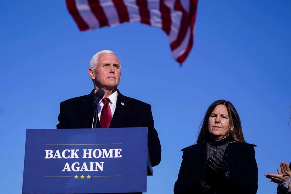 PHOTO: Former Vice President Mike Pence speaks after arriving back in his hometown of Columbus, Ind., as his wife Karen watches, Jan. 20, 2021.