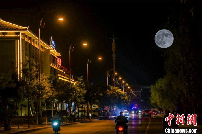 5月26日深夜，一轮超级圆月悬挂在敦煌党河风情线上。(图片为双重曝光)。　王斌银 摄