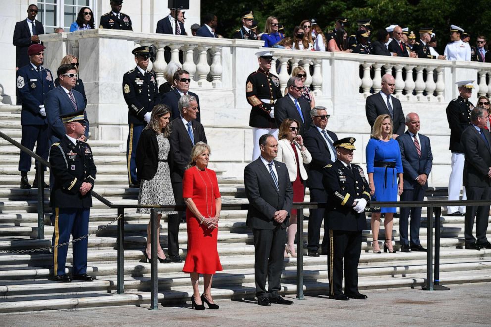 First Lady Jill Biden stands with first gentleman Doug Emhoff and Chairman of Joint Chiefs of Staff General Mark Milley at a wreath laying at the Tomb of the Unknown Soldier at Arlington National Cemetery on Memorial Day in Arlington, Va., May 31, 2021.