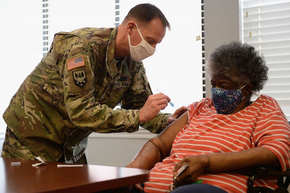 PHOTO: In this Feb. 11, 2021, file photo, Staff Sergeant Herbert Lins of the Missouri Army National Guard administers the Covid-19 vaccine to a resident during a vaccination event in St Louis, Missouri. 