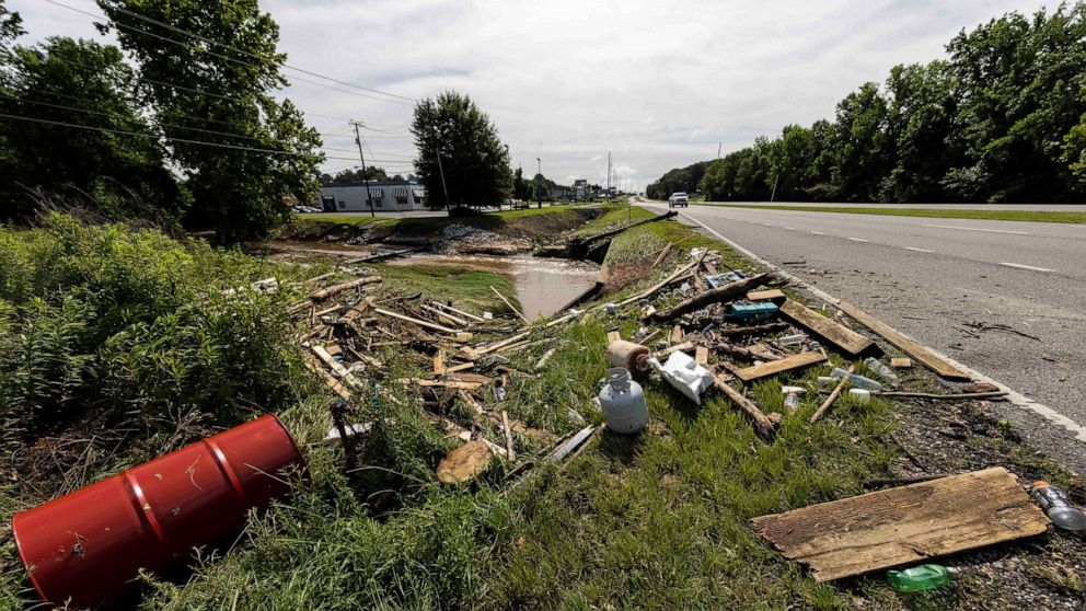 PHOTO: Debris sits along a creek and roadway in Northport, Alabama, June 20, 2021. 