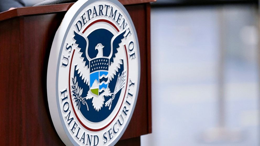 FILE - In this Nov. 20, 2020, file photo a U.S. Department of Homeland Security plaque is displayed a podium as international passengers arrive at Miami international Airport where they are screened by U.S. Customs and Border Protection in Miami. The