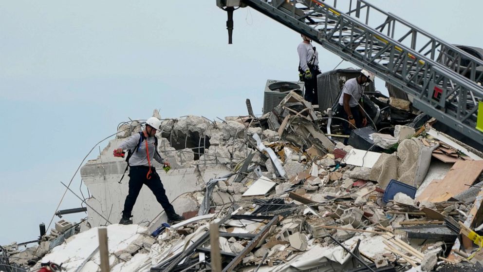 PHOTO: Rescue worker walk among the rubble where a wing of a 12-story beachfront condo building collapsed, June 24, 2021, Surfside, Fla.
