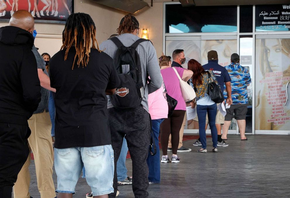 PHOTO: People line up to receive vaccinations at a pop-up COVID-19 vaccination clinic at Larry Flynt's Hustler Club on May 21, 2021, in Las Vegas.
