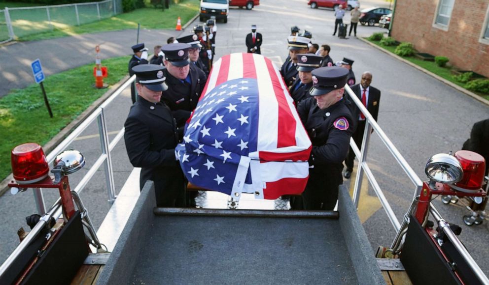 PHOTO: St. Louis Firefighters load the casket of firefighter Rodney Heard, Sr. onto a parade pumper for a memorial service in St. Louis on Monday, June 28, 2021. Heard died in the line of duty from complications due to COVID-19 on June 15, 2021.