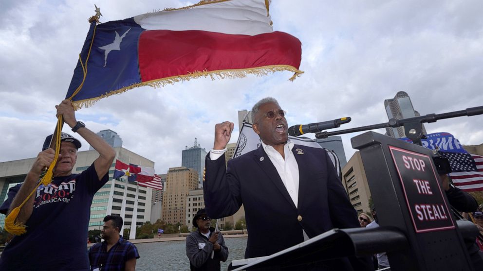 FILE - In this Nov. 14, 2020 file photo, Texas GOP chairman Allen West, right, speaks to supporters of President Donald Trump during a rally in front of City Hall in Dallas. West announced Friday, June 4, 2021, he was stepping down less than a year i