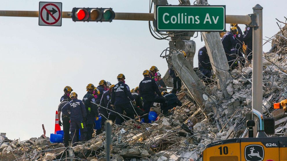 PHOTO: Rescue workers continue working on a pile of debris, July 5, 2021 after the partially collapsed 12-story Champlain Towers South condo was taken down on July 4 with a controlled demolition in Surfside, Fla.