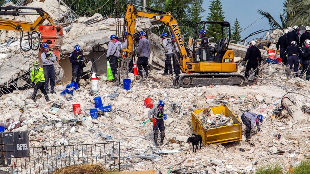 Rescuers search for victims at a collapsed South Florida condo building, July 5, 2021, in Surfside, Fla., after demolition crews set off a string of explosives that brought down the last of the Champlain Towers South building in a plume of dust on Sunday.