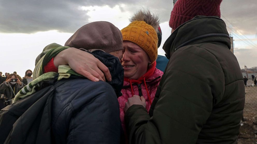 PHOTO: Ukrainian refugees cry as they reunite at the Medyka border crossing, Poland, Feb. 26, 2022.
