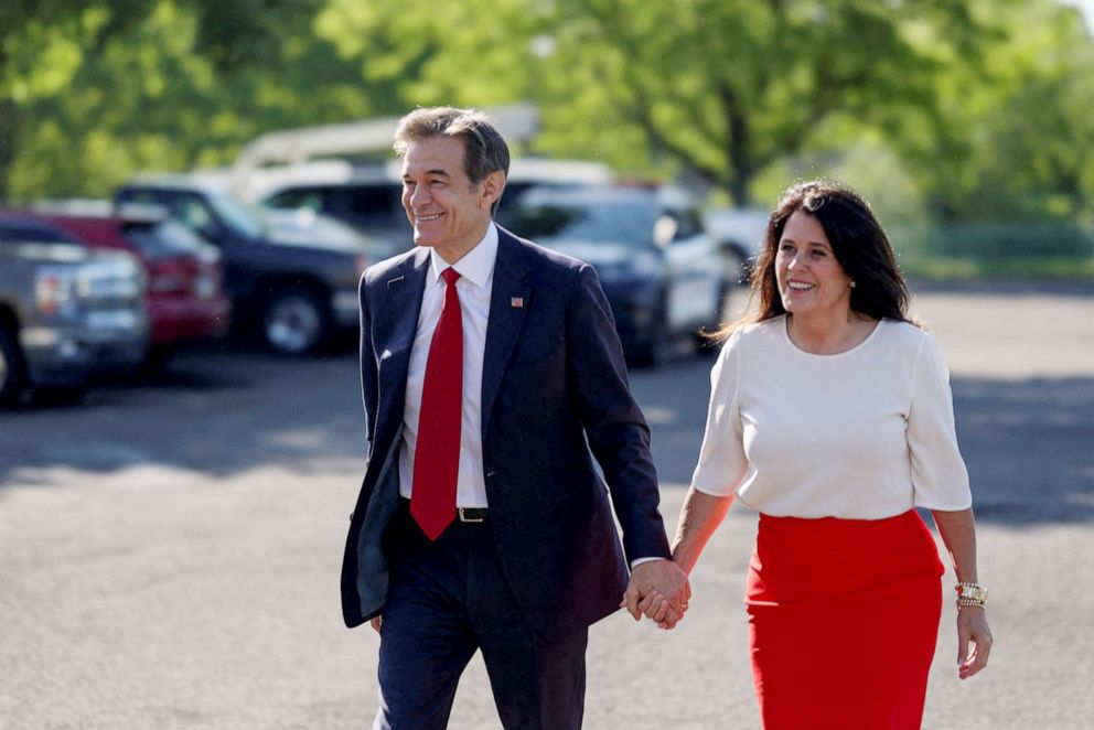 PHOTO: Pennsylvania Republican U.S. Senate candidate Dr. Mehmet Oz and his wife Lisa Oz arrive to cast their vote, in Bryn Athyn, Pa., May 17, 2022. 