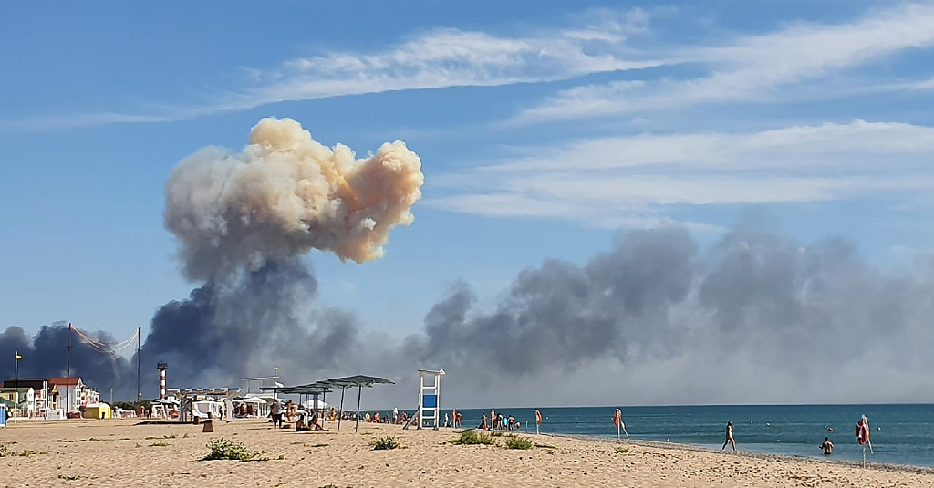 当地时间2022年8月9日，克里米亚新费多罗夫卡地区，海滩上能看到升起的烟雾。萨基机场一处航空弹药储存区当天发生爆炸事故。视觉中国 图