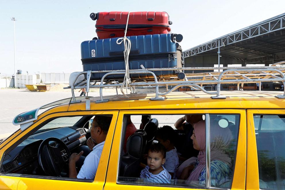 PHOTO: People sit inside a car as Palestinians, including foreign passport holders, wait at Rafah border crossing after evacuations were suspended following an Israeli strike on an ambulance, in Rafah in the southern Gaza Strip, Nov. 5, 2023.