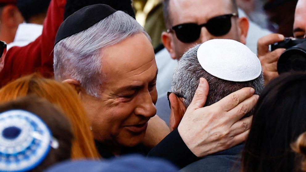 PHOTO: Israeli cabinet minister and former military chief Gadi Eizenkot is consoled by Israeli Prime Minister Benjamin Netanyahu, as he attends the funeral of his son, soldier Gal Meir Eisenkot, in Herzliya, Israel, Dec. 8, 2023. 